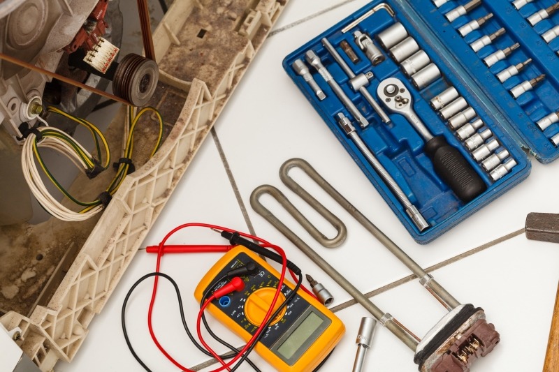 Engineer repairing a washing machine in Waltham Abbey